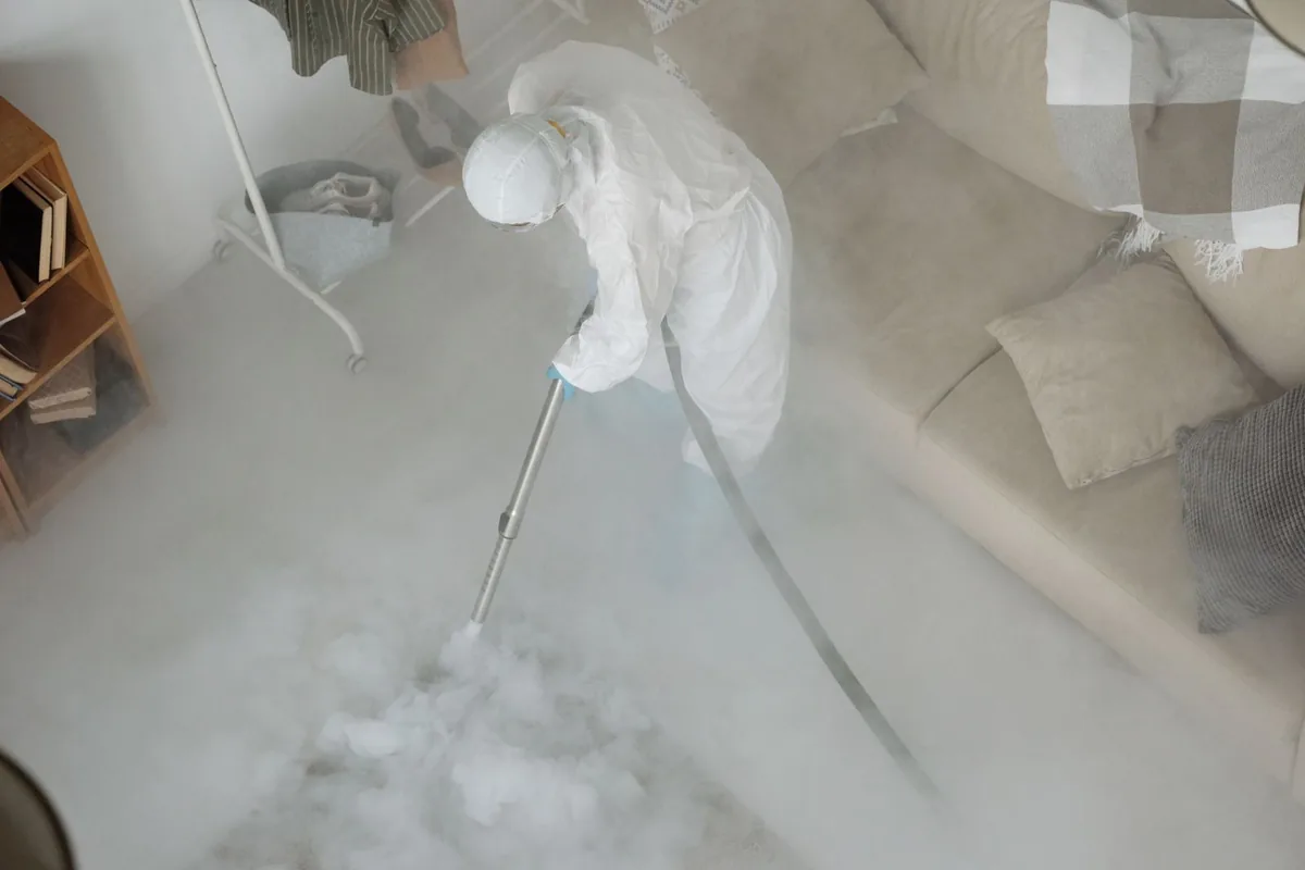 Biohazard cleanup technician in protective equipment, La Monte, MO